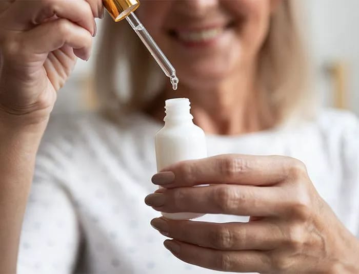 woman-holding-skincare-serum