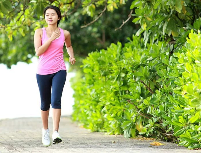 young woman walking in a park