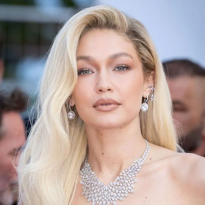 gigi hadid blonde hair silver necklace dangly earrings