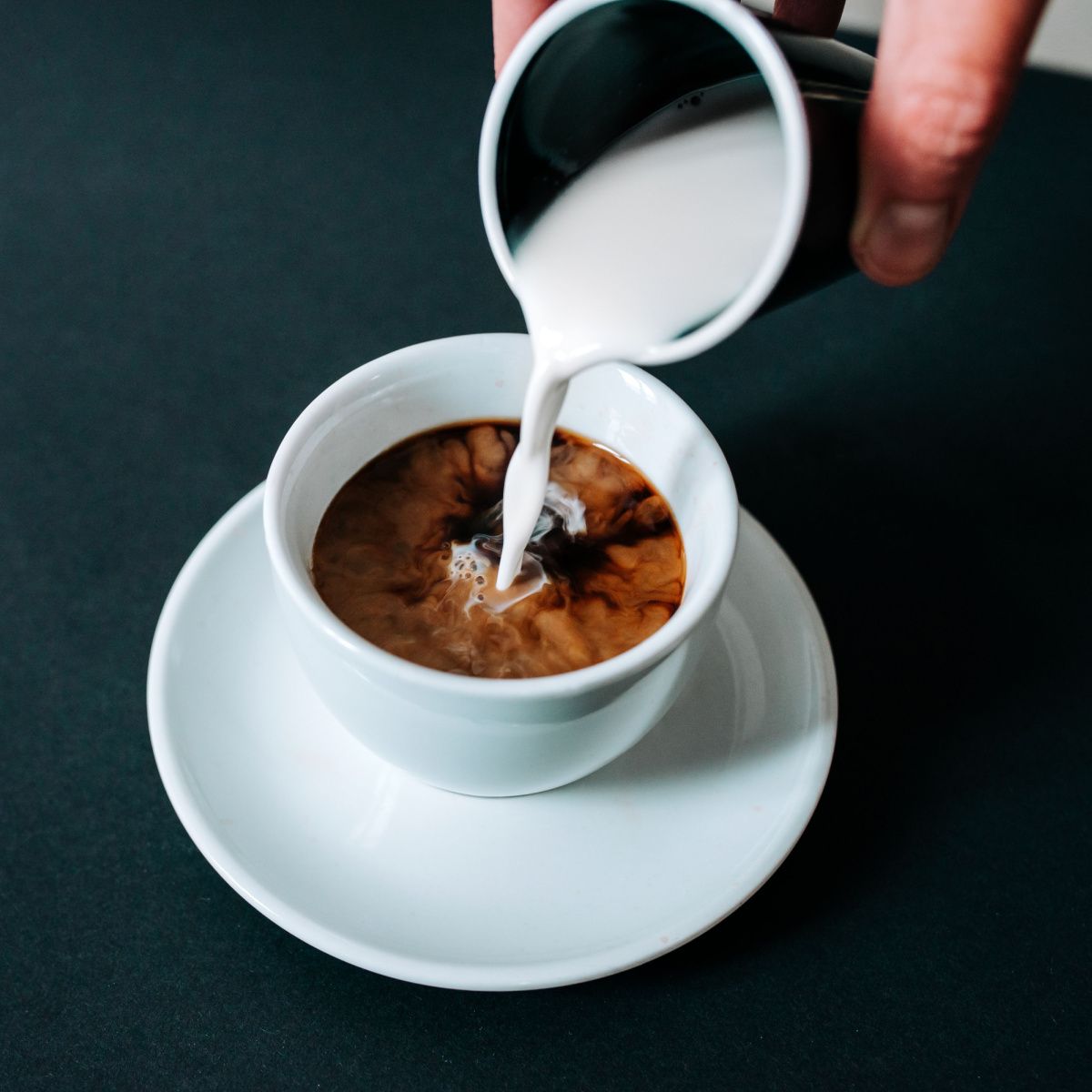 coffee creamer poured into a cup
