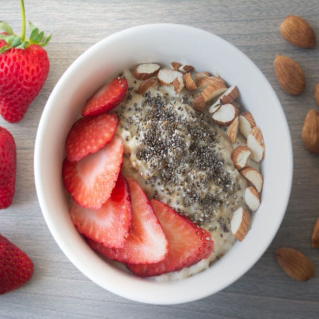 oatmeal topped with strawberries, chia seeds, almonds