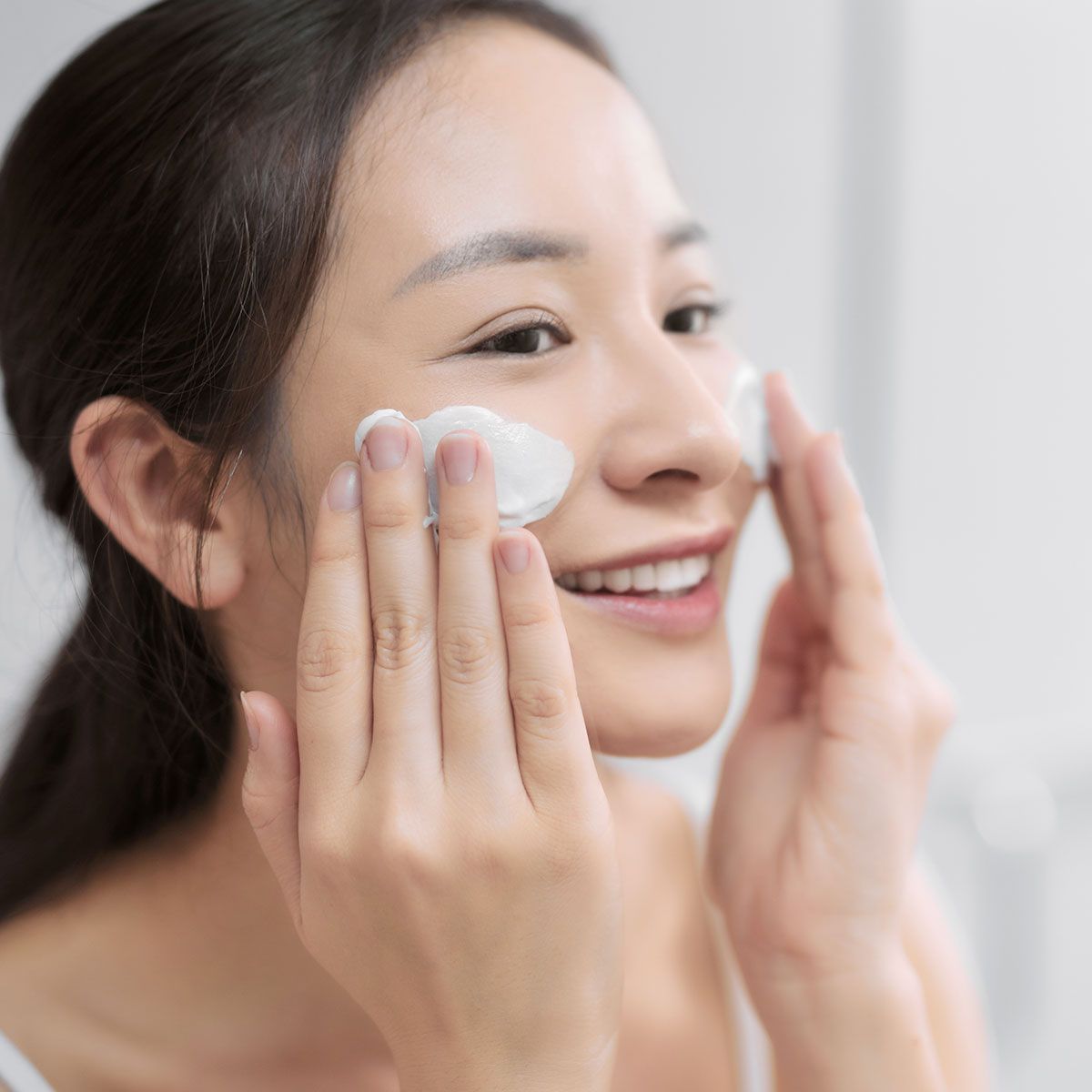 woman-applying-face-cream