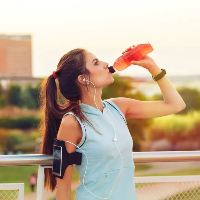 woman drinking sports drink
