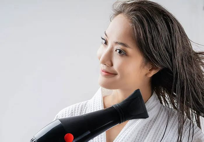 woman-blow-drying-hair