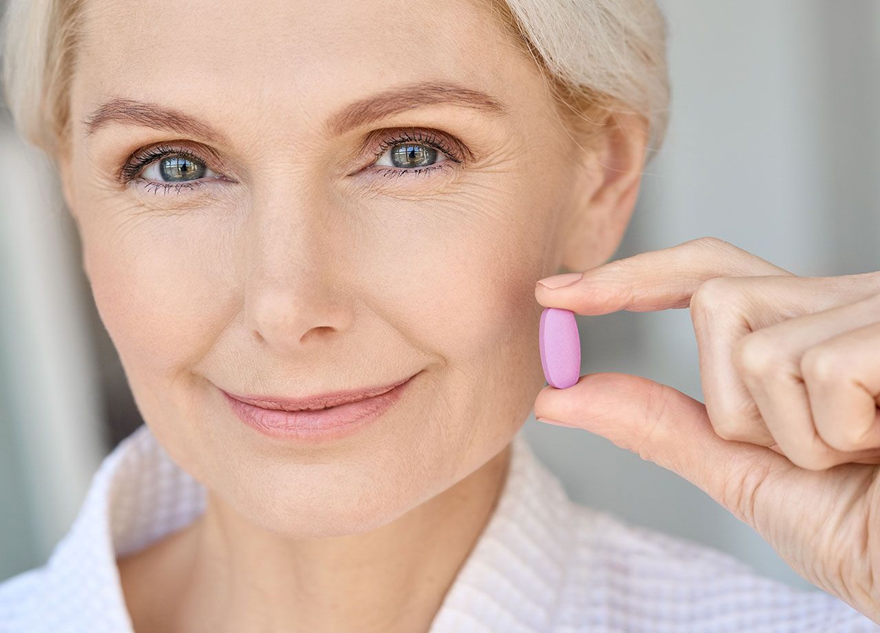 older-woman-holding-vitamin