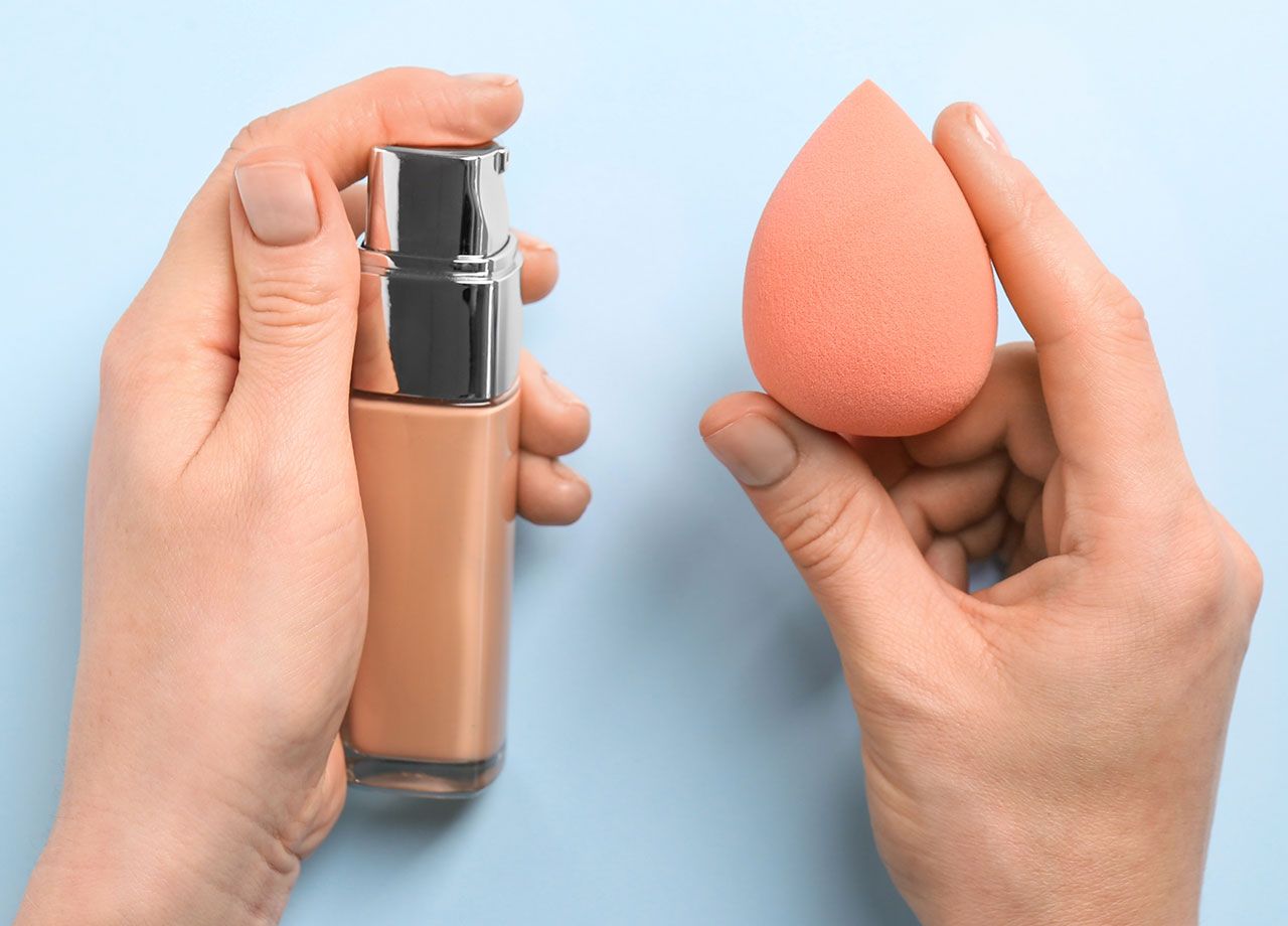 woman-holding-foundation-sponge