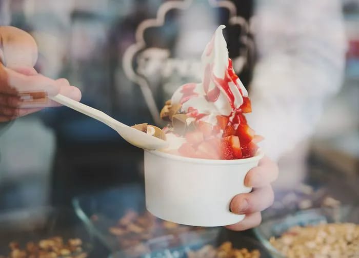 person serving frozen yogurt