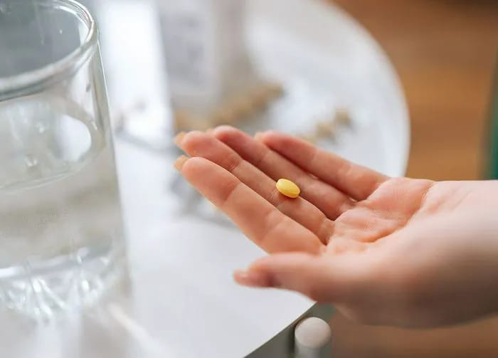 woman-taking-vitamin