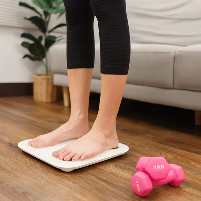 woman standing on scale