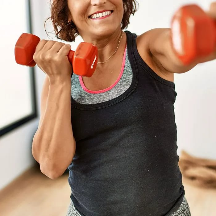 Anonymous woman smiling during morning workout session.