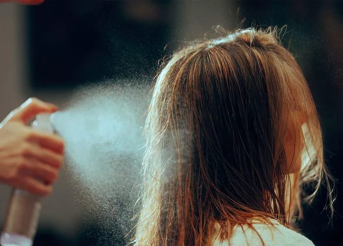hair-stylist-using-hair-spray