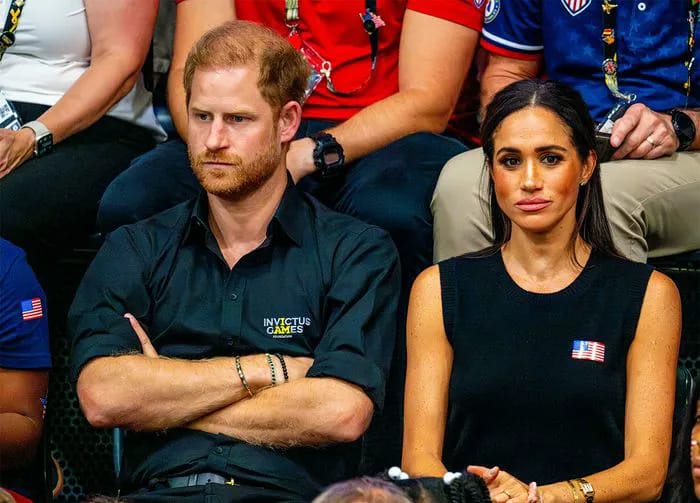 Prince Harry and Meghan Markle looking upset
