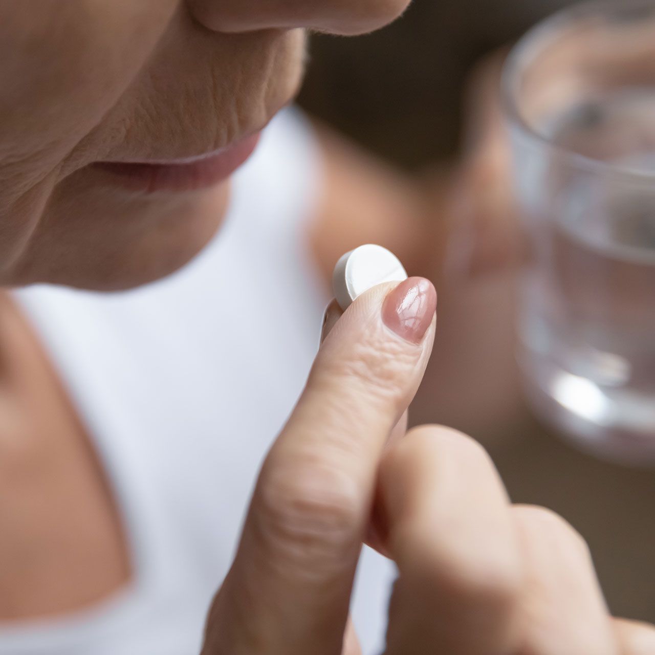 older-woman-taking-pill
