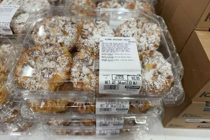 Delicious Kirkland Signature almond croissant pastry on a white plate.