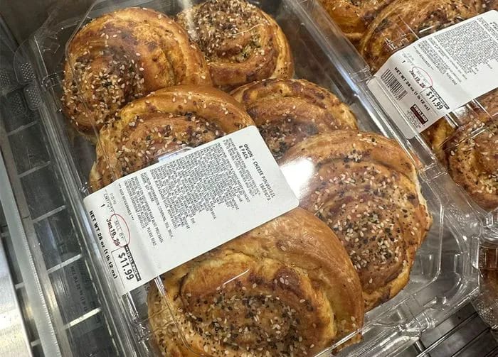 Savory Kirkland Signature onion cheese pinwheels served on a wooden board.
