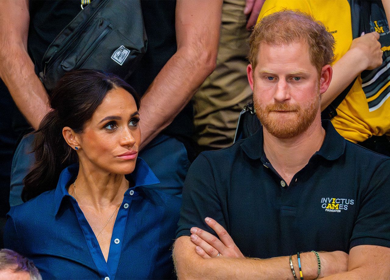 Prince Harry and Meghan Markle looking intense