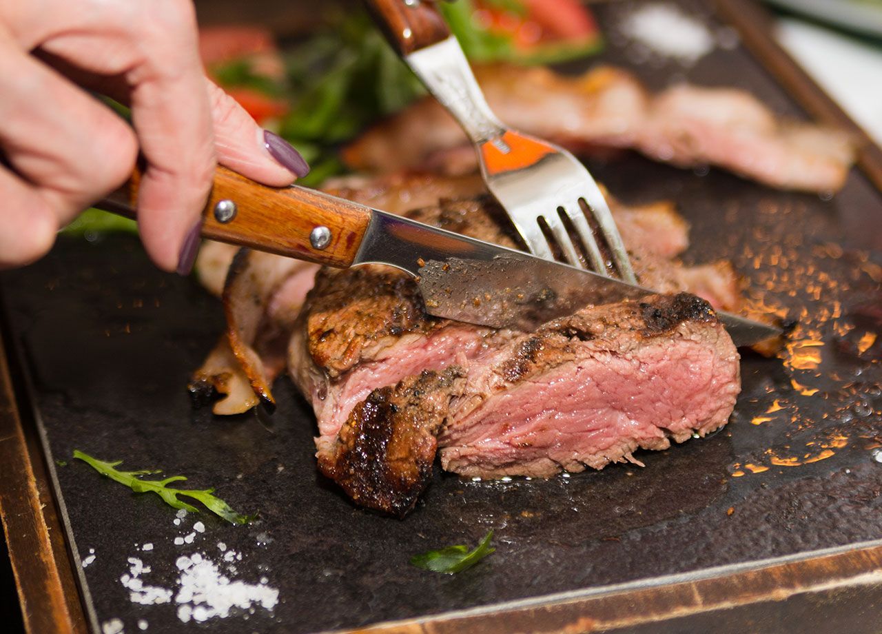 woman-cutting-steak