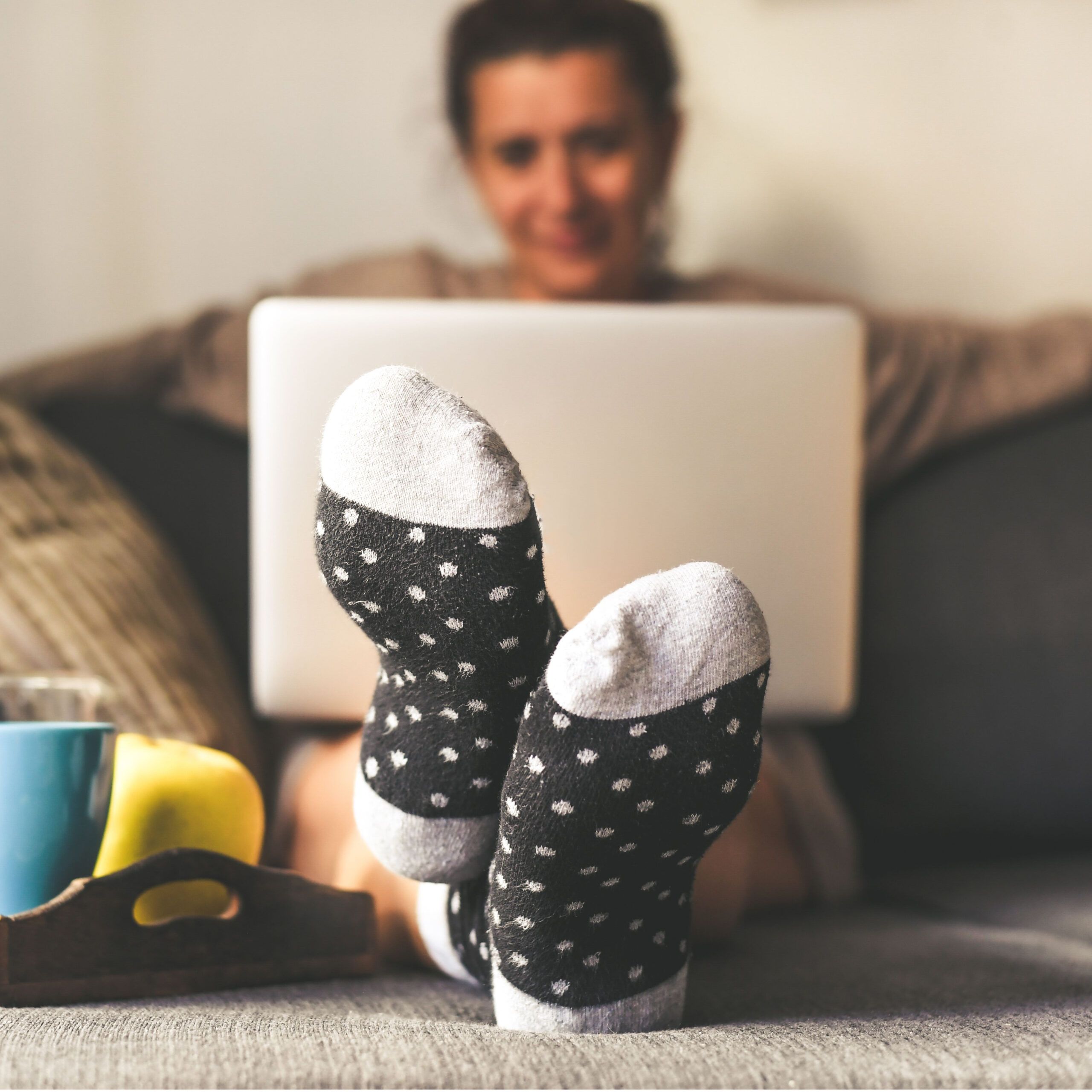 woman on couch on laptop