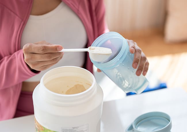woman making a protein shake