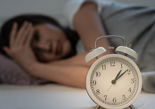 woman-looking-at-alarm-clock