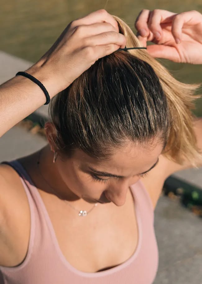 woman-tying-ponytail