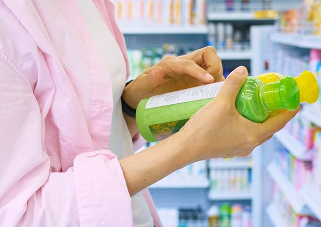 woman-reading-back-shampoo-bottle