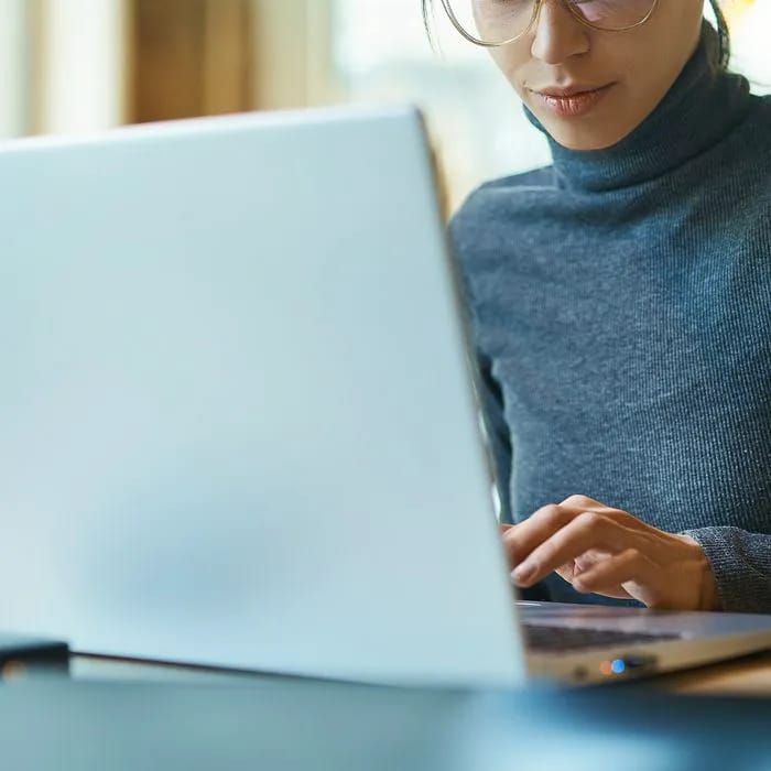 Woman working on a laptop.