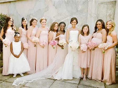 Tamera Mowry surrounded by her wedding party in beautiful attire.