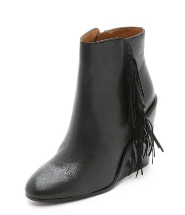 See by Chloe Fringe Wedge Booties See by Chloe's trendy accessories featured in a fashionable setting.