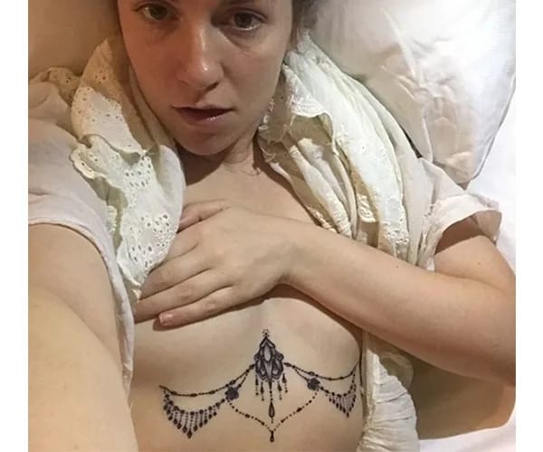 "Lena Dunham showing off her tattoo"