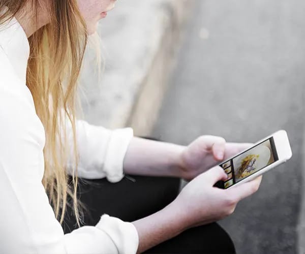 Consider The Size Of Your Hands "Person holding an iPhone with two hands"