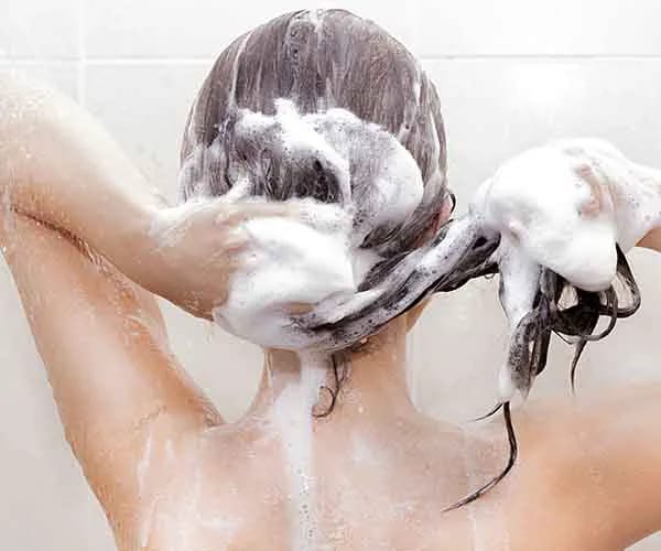 woman washing hair in shower
