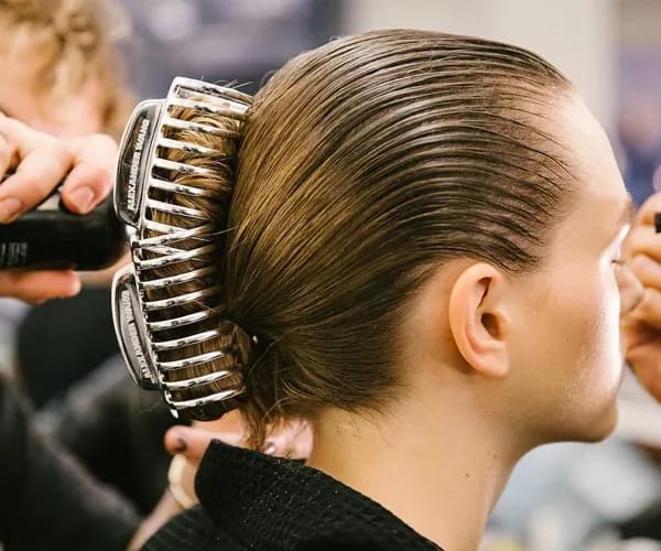 model with banana clips holding up hair in bun