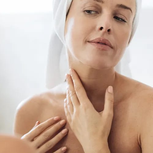 checking skin in mirror