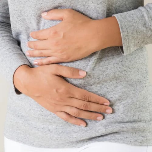 woman holding stomach