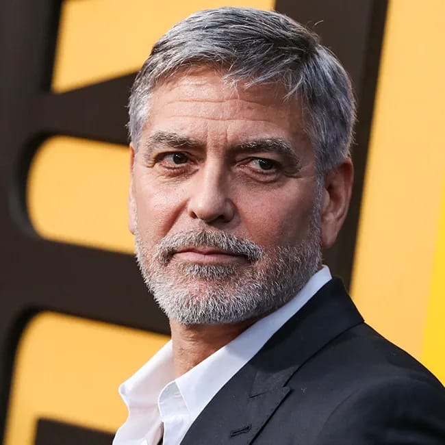 George Clooney posing for a top photo.