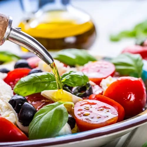 dressing salad with olive oil