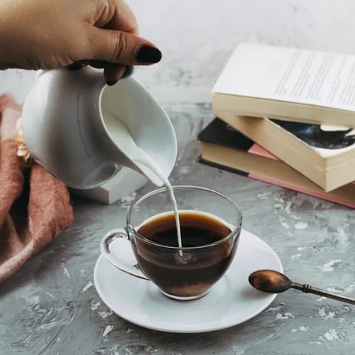 Creamer being poured into coffee