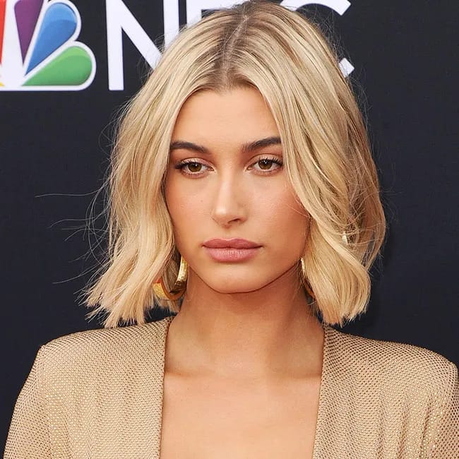 Hailey Bieber poses confidently, highlighting her signature style.
