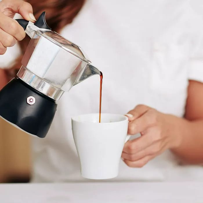 Pouring a cup of coffee from a pot