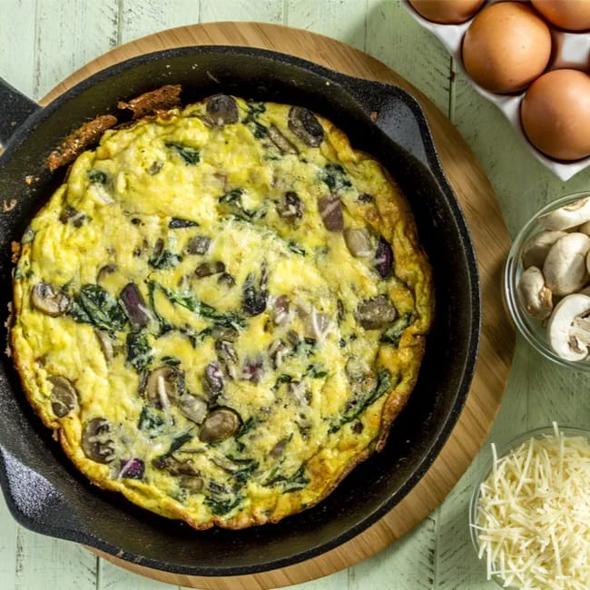 Delicious mushroom and spinach frittata on a plate.