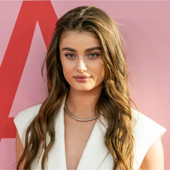 Taylor Hill poses elegantly, representing contemporary celebrity fashion.