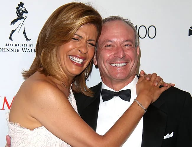 hoda kotb smiling hugging joel schiffman on red carpet