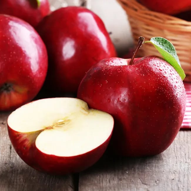 Red apples arranged artistically on a wooden surface.