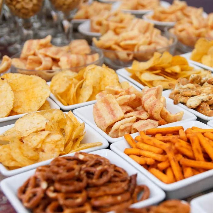 "Savory salty snacks in decorative dishes"
