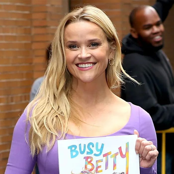 "Reese Witherspoon smiling on the red carpet"
