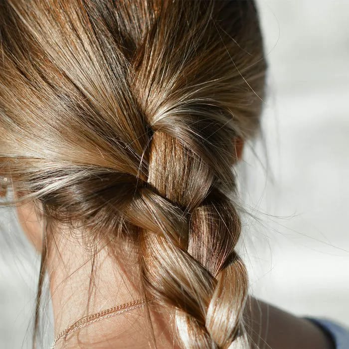 Hairdresser spraying hairspray on curls