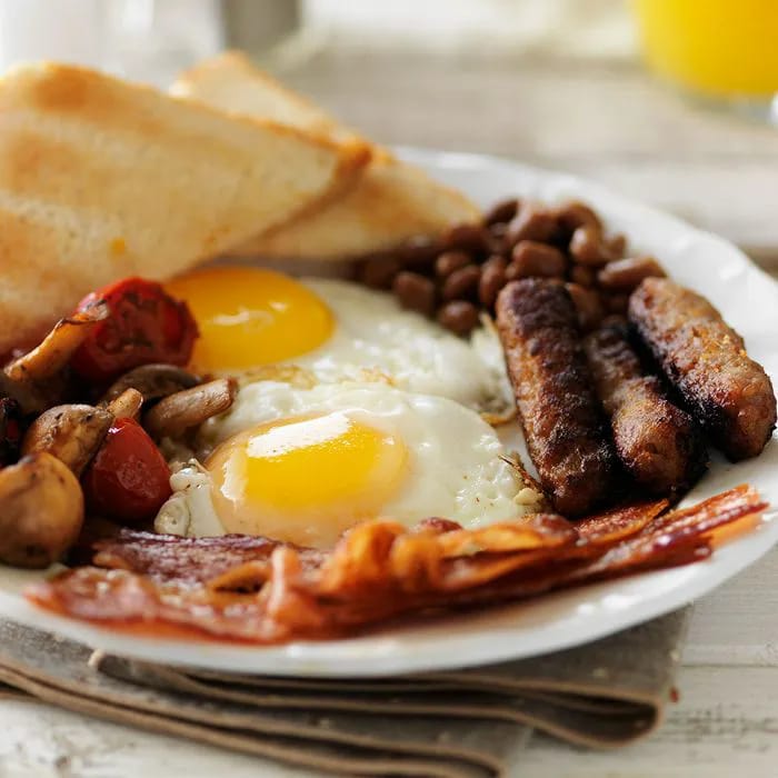 "Breakfast plate with sausage and bacon"