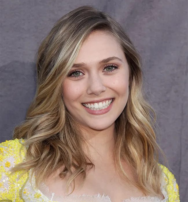 elizabeth olsen side parted wavy blonde hair sideswept bangs yellow dress