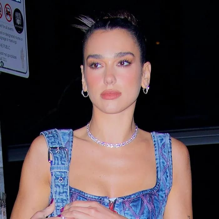 Dua Lipa posing confidently for a photoshoot.